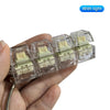 A hand holds several clear plastic LED mechanical keychain fidget toys with custom keycaps.