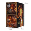 A wooden DIY book nook kit featuring a detailed miniature tavern scene with lighting and decor.