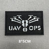 Black embroidered patch with white graphic featuring a stylized insect or gear design and the text UAV OPS