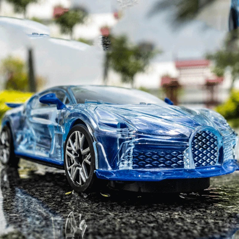 A blue police car toy with lights and sounds parked on a wet, dark surface.