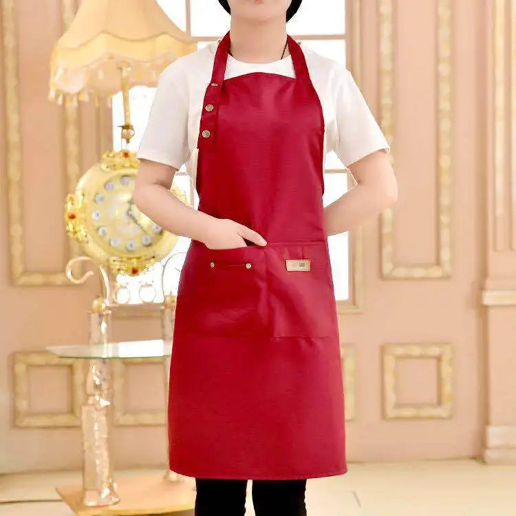 A woman wearing a red cotton apron over a white shirt standing in a brightly lit room.