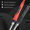 A close-up view of a red electronic soldering iron with a silver tip resting on a black surface.