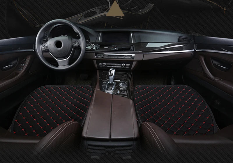 Interior view of a car showing a steering wheel, dashboard, and front seats covered with dark brown leather and patterned fab