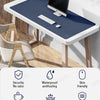 A dark blue premium PU leather desk mat with a black monitor and keyboard on a wooden desk.