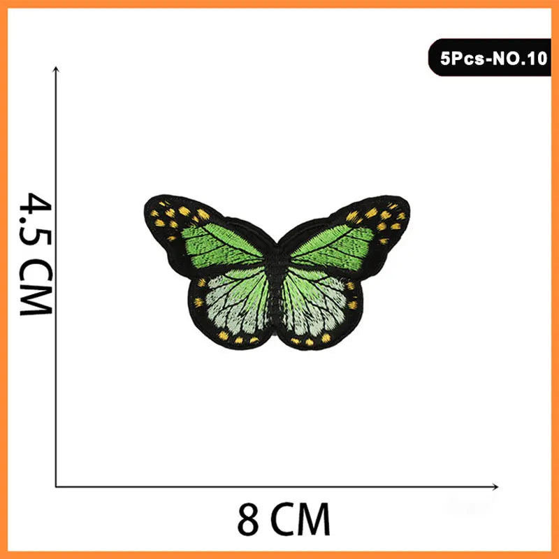 Five embroidered butterfly iron-on patches with yellow accents on a white background.