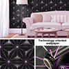 A pink sofa in a modern interior featuring a geometric purple and black wallpaper pattern.