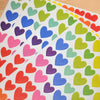 A sheet of rainbow dot stickers featuring various colored hearts.