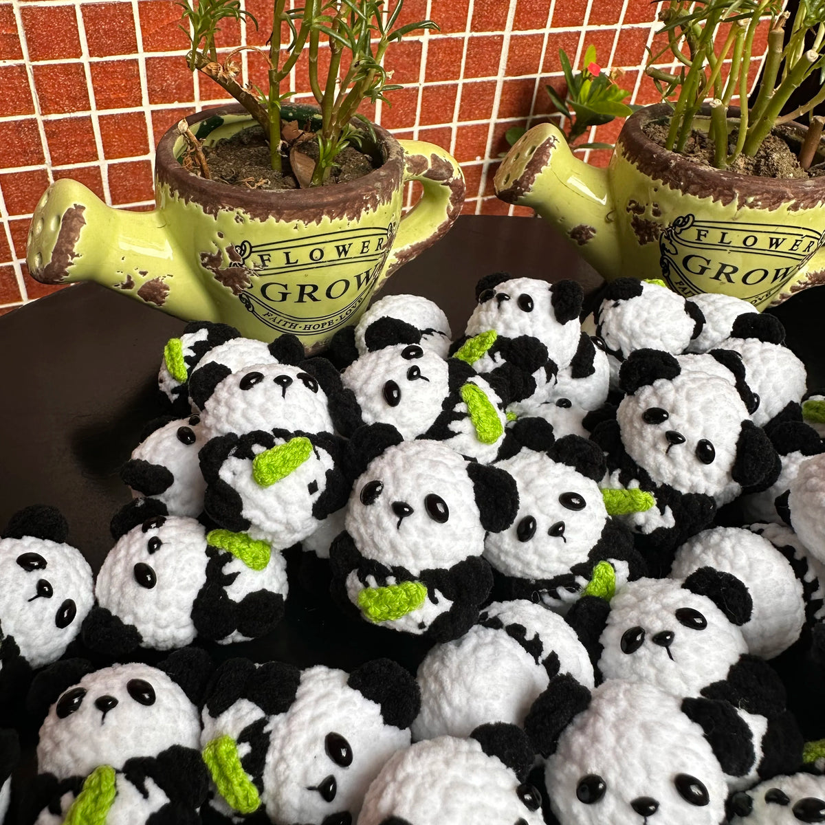A collection of handmade crochet kitten keychains featuring cute panda and cartoon animal charms.