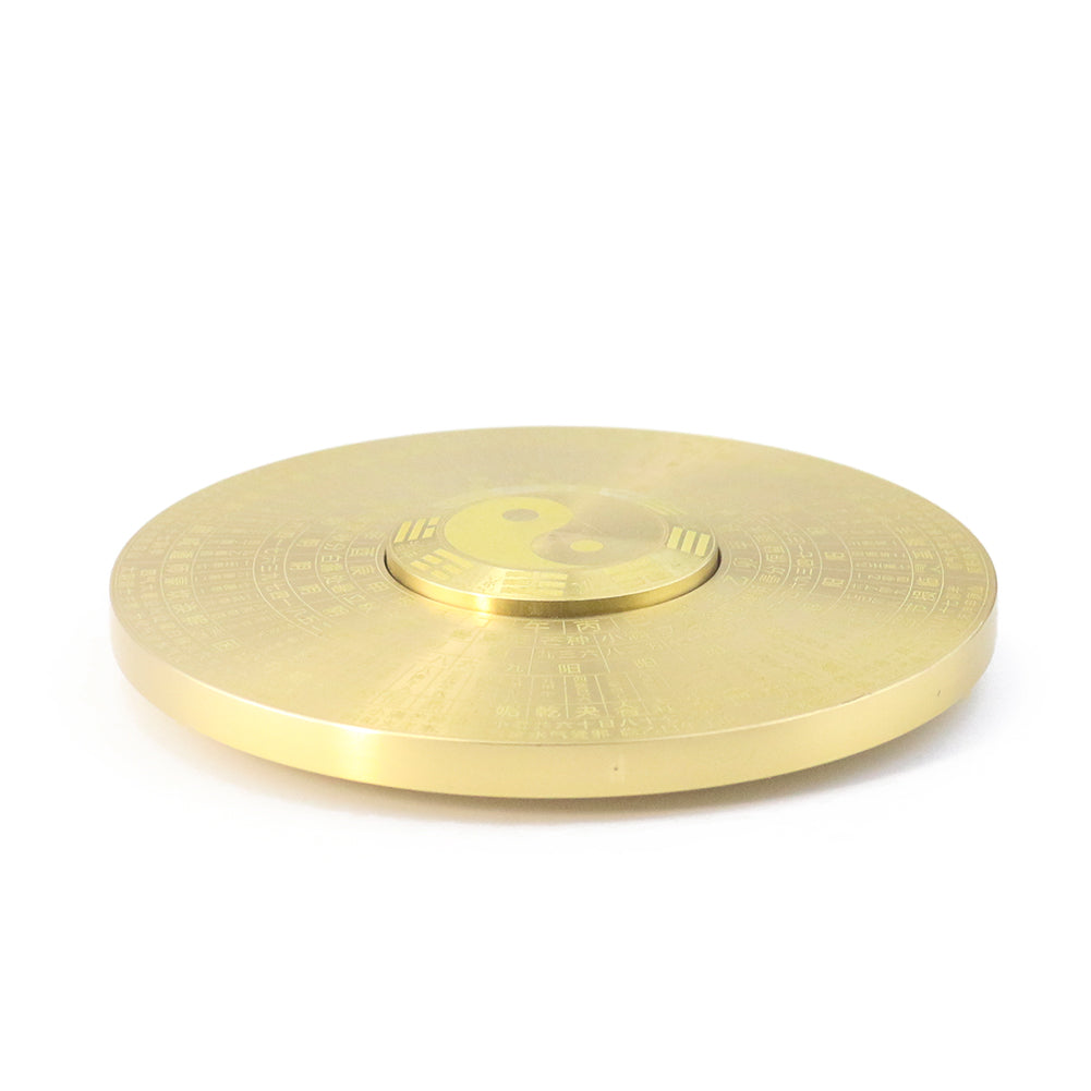Solid brass Feng Shui compass featuring Yin Yang and eight trigrams on a circular disc.