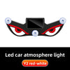 A black demon eye LED car window decal with red and white lights.