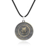 A silver pendant necklace featuring a detailed skull design within a circular, sun-like motif.