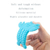 A hand holds a bright blue silicone baby teether toy shaped like a remote control keypad.