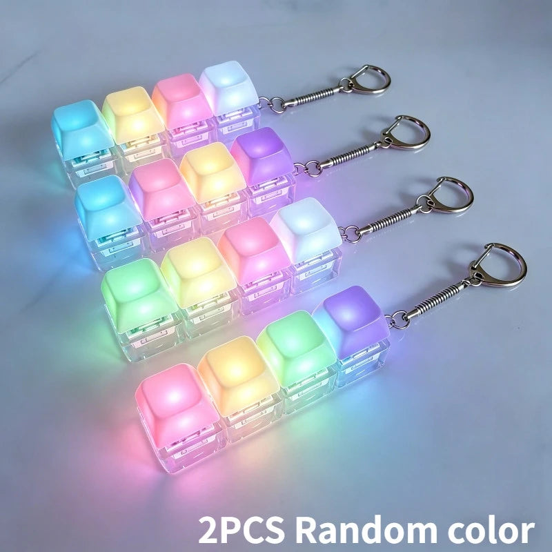 Two pairs of LED macaron keyboard fidget toys with random colors attached to metal keychains