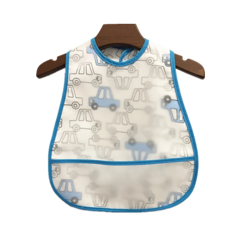 A white baby feeding bib with a blue trim and a catch pocket hanging on a wooden hanger.