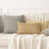 A set of corduroy throw pillow covers in various neutral tones including beige, gray, and olive green displayed on a white so