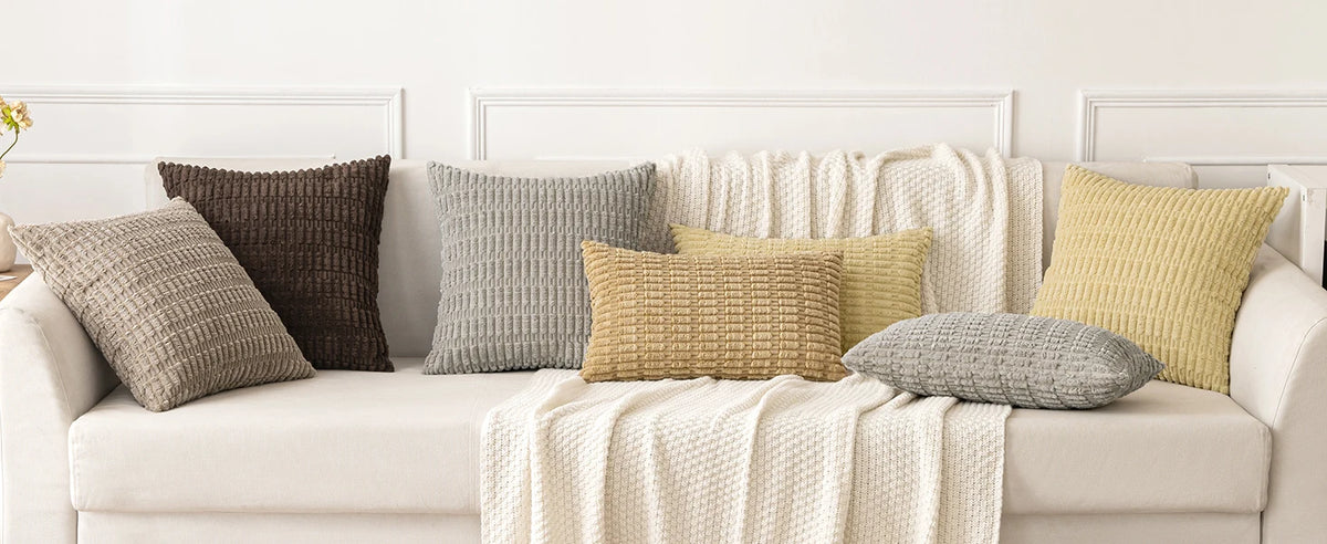 A set of corduroy throw pillow covers in various neutral tones including beige, gray, and olive green displayed on a white so