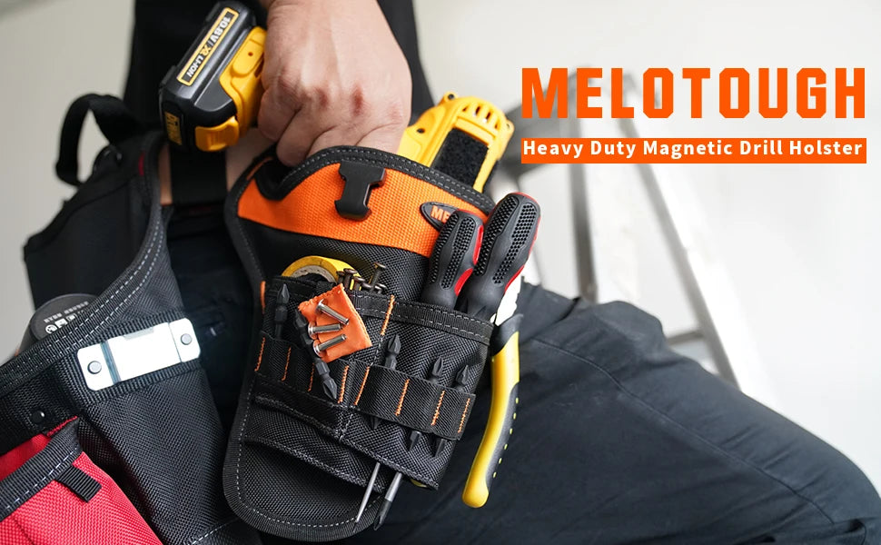 A hand holds a black and orange heavy duty magnetic drill holster attached to a tool bag.