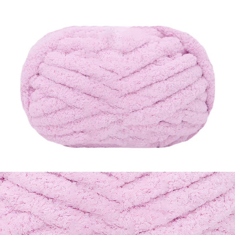 A ball of pink chunky chenille yarn used for hand knitting and crochet