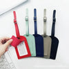 A hand holds a classic PU leather luggage tag in various colors including red, green, blue, and black.