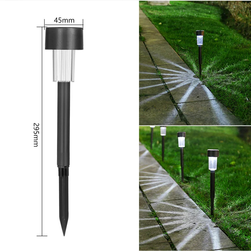 A black solar powered garden lantern light mounted on a stake, illuminating a pathway with light patterns.