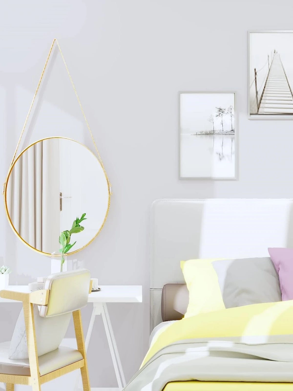 A bedroom setting featuring a white headboard, yellow bedding, and a gold-framed mirror above a light wood desk.