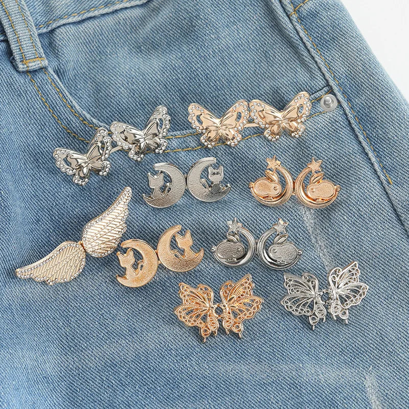 Silver and gold butterfly and crescent moon jewelry attached to a denim fabric