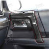 Close-up of a black carbon fiber trim kit installed on the interior panel of a vehicle.