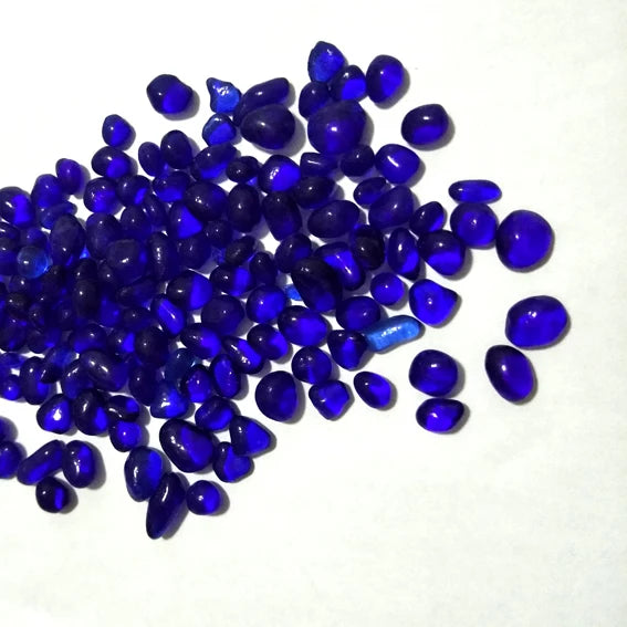 A pile of small, deep blue decorative stone pebbles for terrariums and aquariums.
