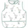 A white waterproof full-body baby feeding bib with a sleeveless design featuring several small white ducklings.