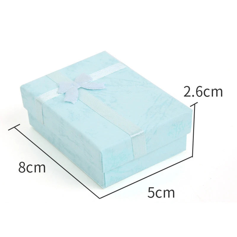 Light blue velvet jewelry gift box with a sheer ribbon tied on top