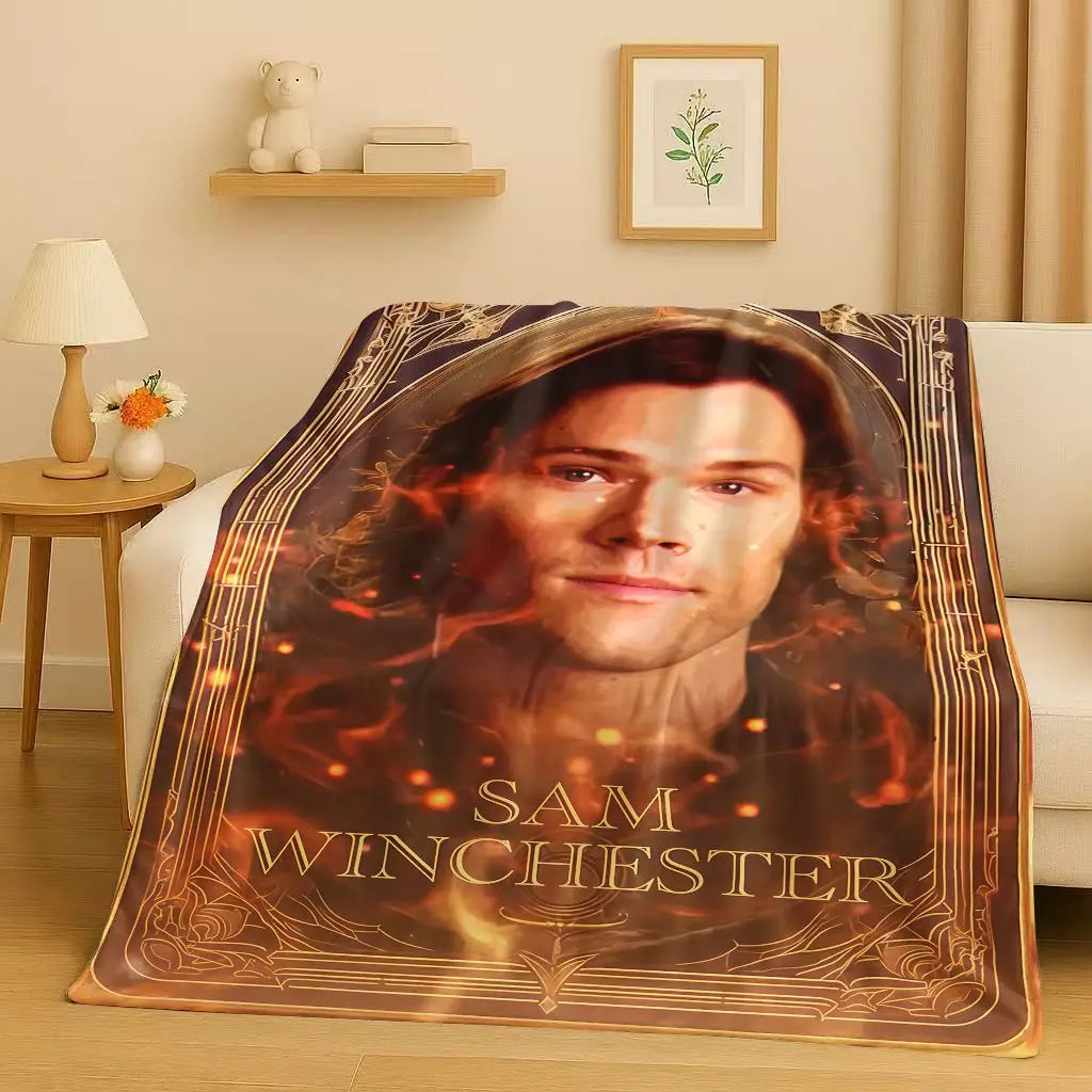 A blanket featuring a portrait of Sam Winchester from the Supernatural TV show on a dark background.