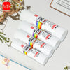 A collection of white PVA glue sticks with colorful tips is displayed on a white surface.