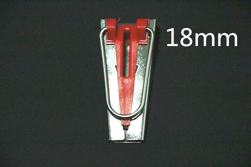 A close-up view of a red and silver bias tape maker tool with an 18mm measurement mark.