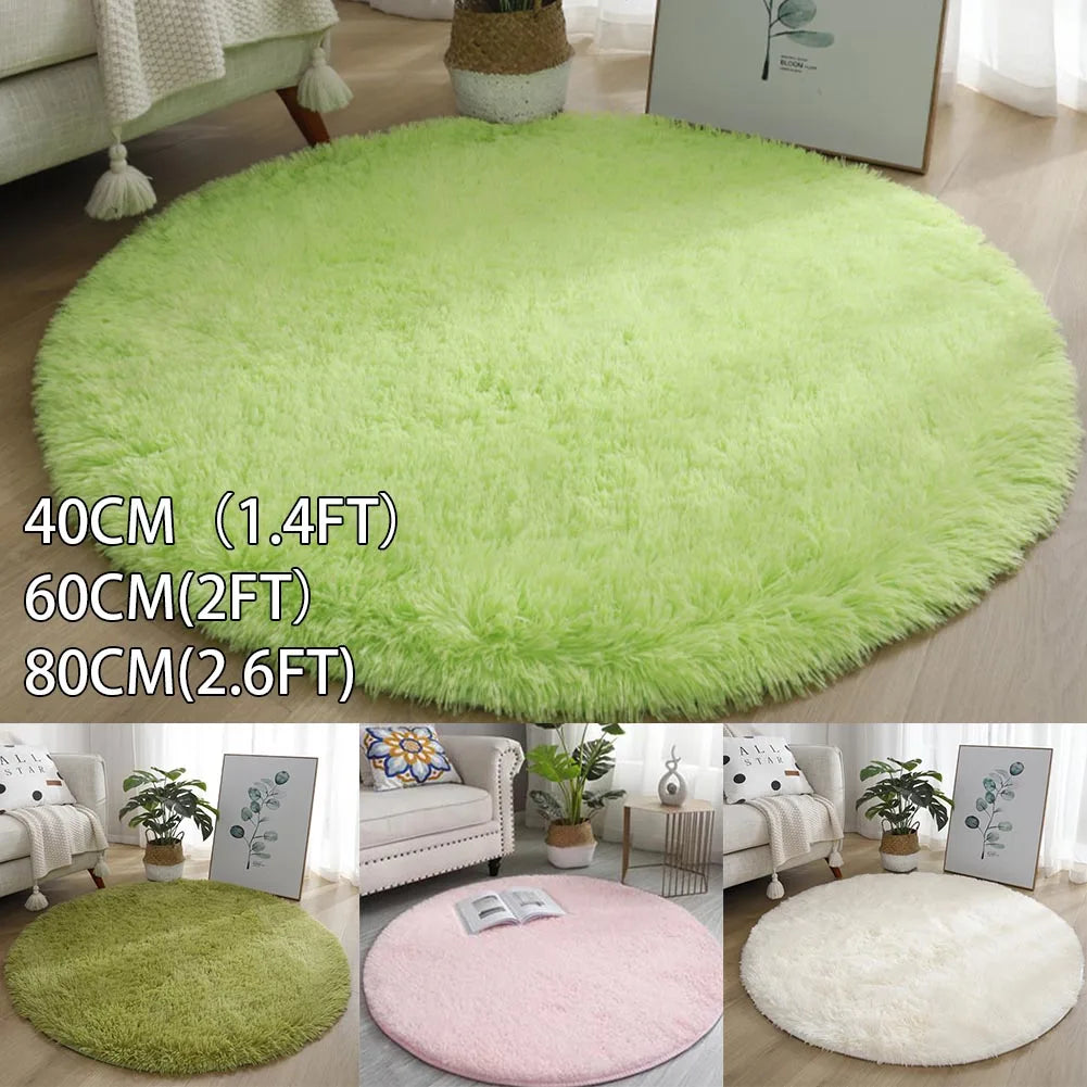 A collection of round, ultra-soft, shaggy rugs in various shades of green and pink on a wooden floor.