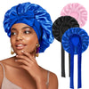 A woman wearing a blue satin sleeping bonnet and matching hair accessories.