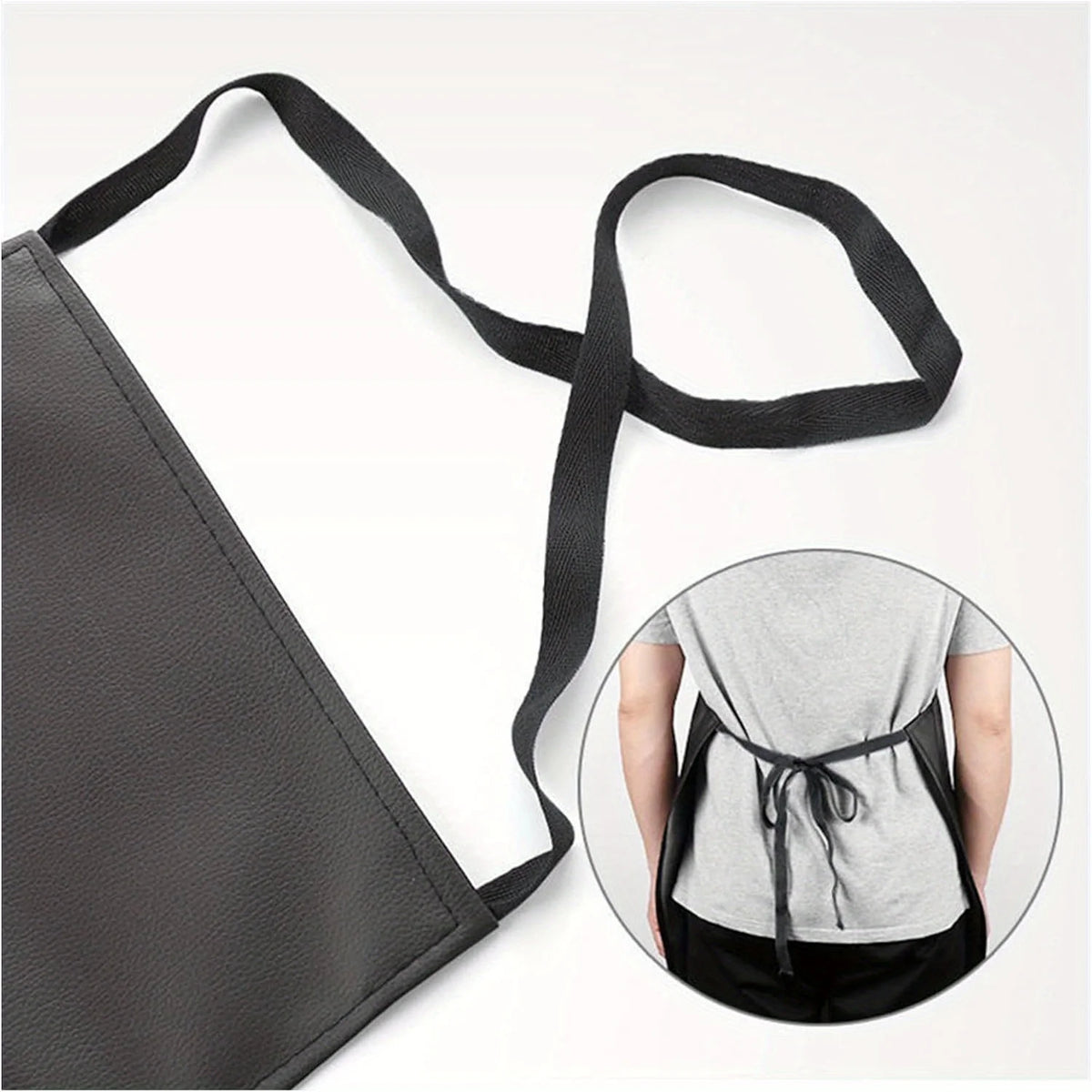 A black PU leather waterproof apron with adjustable straps shown next to a person wearing it.