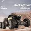 A yellow rock offroad climbing car is jumping over rough terrain on a dusty road.
