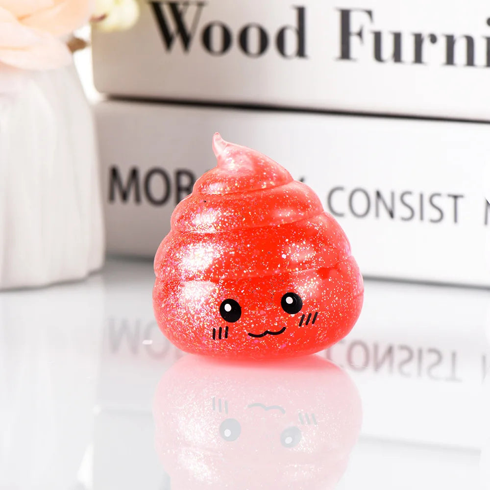 A bright red squishy toy shaped like a smiling face resting on a reflective surface.