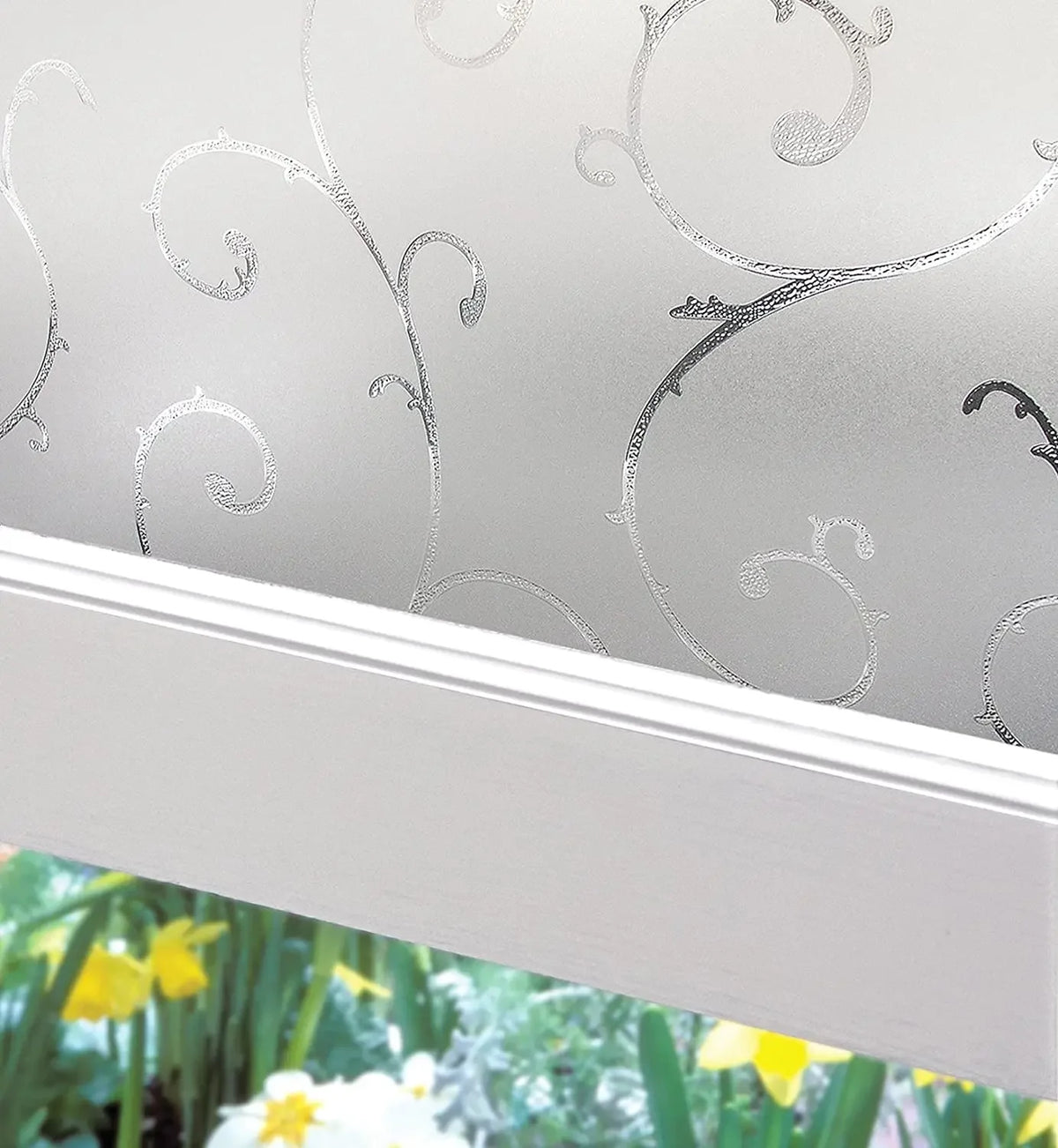 Close-up of frosted stripe privacy window film applied to a white window frame, showing decorative swirling patterns.