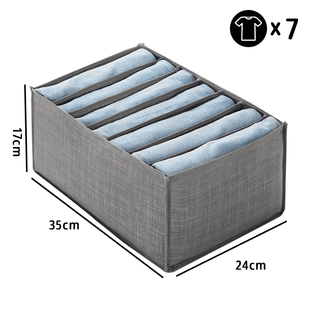A gray fabric closet organizer with seven folded blue garments visible inside.