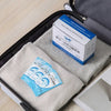 A box of disposable toilet seat covers is shown inside a black travel case with a light gray fabric lining.