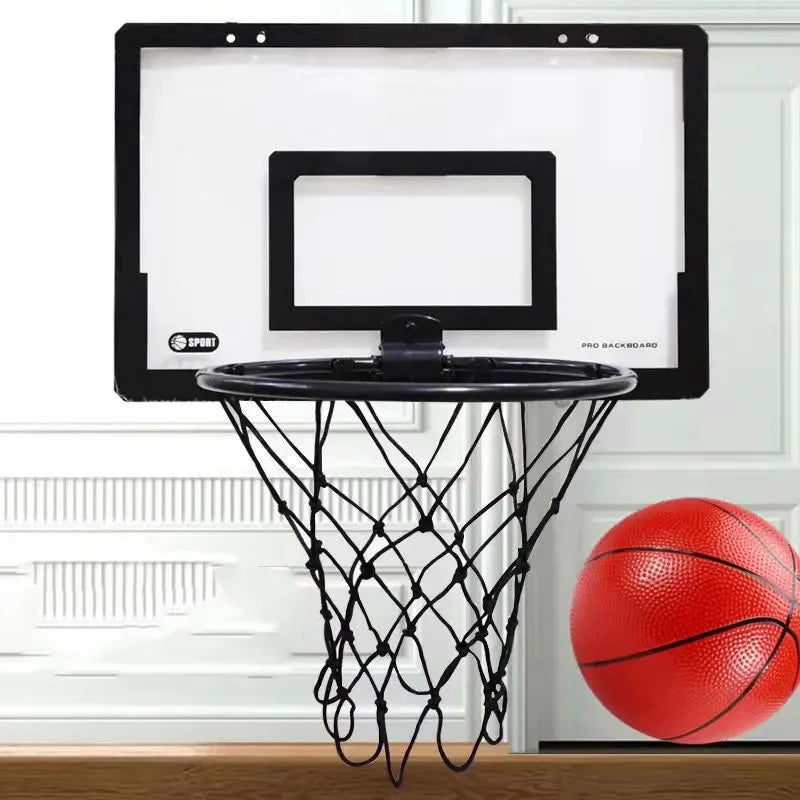 A portable mini basketball hoop set with a black backboard and net is mounted on a wooden surface.