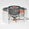 A portable aluminum alloy windshield for camping stoves with a dark pot and orange handle.