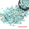 A pile of light blue Amazonite crystal chips and tumbled stones.