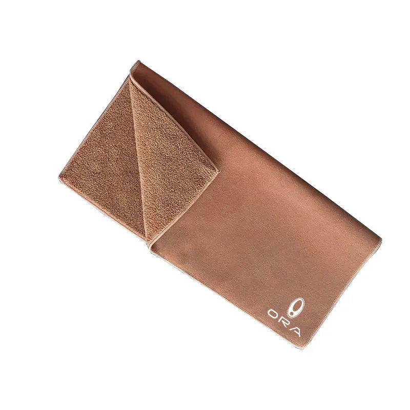 A folded brown ultra-soft coral fleece car drying towel with the brand name ORA visible.