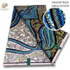 A bolt of pink glitter African wax print fabric featuring intricate blue, gold, and black swirling patterns.