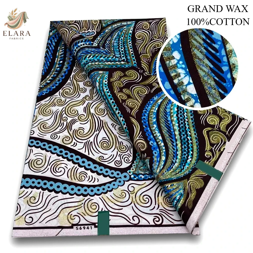A bolt of pink glitter African wax print fabric featuring intricate blue, gold, and black swirling patterns.