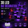 A set of 12 or 24 LED bat decorations featuring glow-in-the-dark bats and bat wings displayed on a stand.