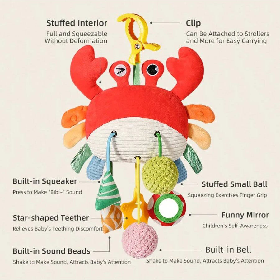 A colorful hanging baby rattle and teether toy featuring a cartoon sea creature with various attachments for sensory play.