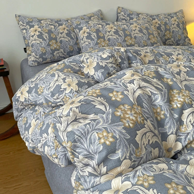 A gray duvet cover set featuring a floral pattern in beige and white tones.